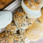 Donations Close-up of assorted breads with sesame seeds on a wooden board.